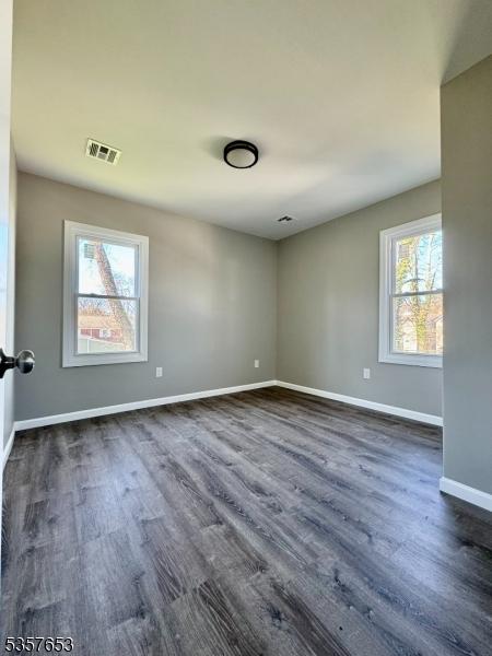 261 Hickory St, City Of Orange Twp, NJ 07050 - unfurnished room with dark wood-style floors and baseboards