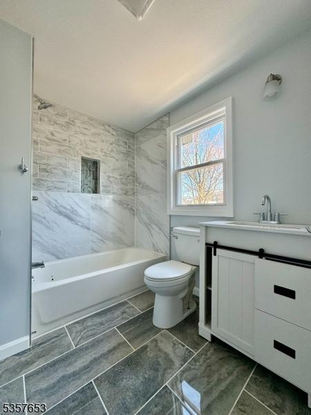 261 Hickory St, City Of Orange Twp, NJ 07050 - full bathroom featuring toilet, vanity, washtub / shower combination, and marble finish flooring