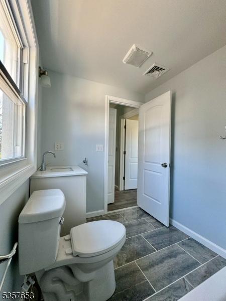 261 Hickory St, City Of Orange Twp, NJ 07050 - bathroom featuring a sink, toilet, and baseboards