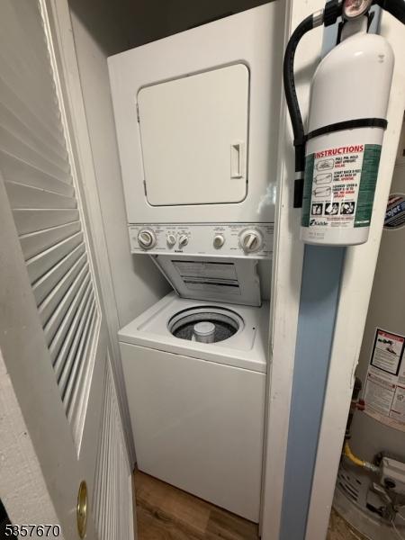 7 Deer Valley Ln Unit 6, Vernon Twp, NJ 07462 - washroom featuring stacked washer / drying machine and wood finished floors