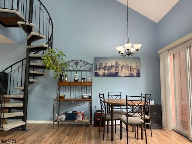 7 Deer Valley Ln Unit 6, Vernon Twp, NJ 07462 - dining space featuring high vaulted ceiling, stairway, wood finished floors, and a chandelier
