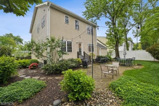 back of property with a patio area and entry steps