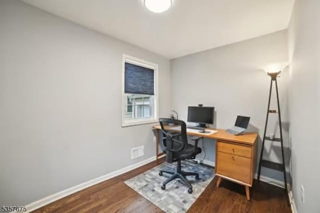office with baseboards and dark wood finished floors