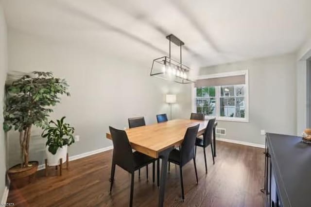 dining space with dark wood-style floors and baseboards