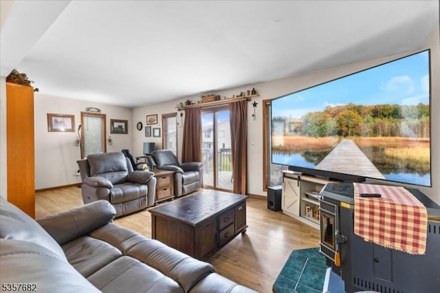 287 Cheyenne Rd, Andover Twp, NJ 07848 - living area with wood finished floors, a wood stove, and baseboards