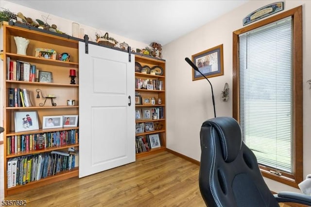 287 Cheyenne Rd, Andover Twp, NJ 07848 - office area with light wood-type flooring, baseboards, and a barn door