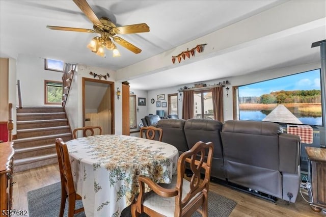 287 Cheyenne Rd, Andover Twp, NJ 07848 - dining area with wood finished floors, a ceiling fan, stairway, and a water view