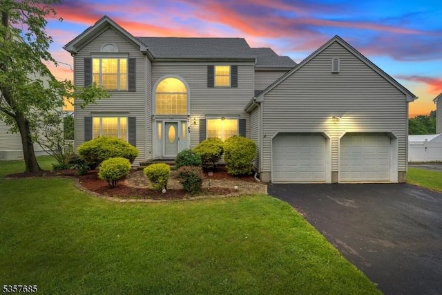 65 Vones Ln, Raritan Boro, NJ 08869 - traditional home featuring asphalt driveway, a front lawn, and a garage
