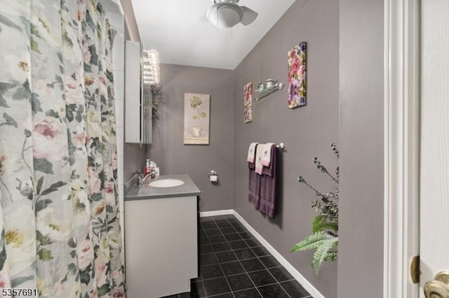 bathroom featuring tile patterned floors, vanity, ceiling fan, baseboards, and a shower with curtain