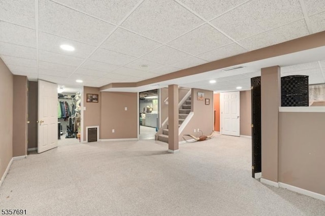 finished below grade area featuring carpet floors, baseboards, stairs, and recessed lighting