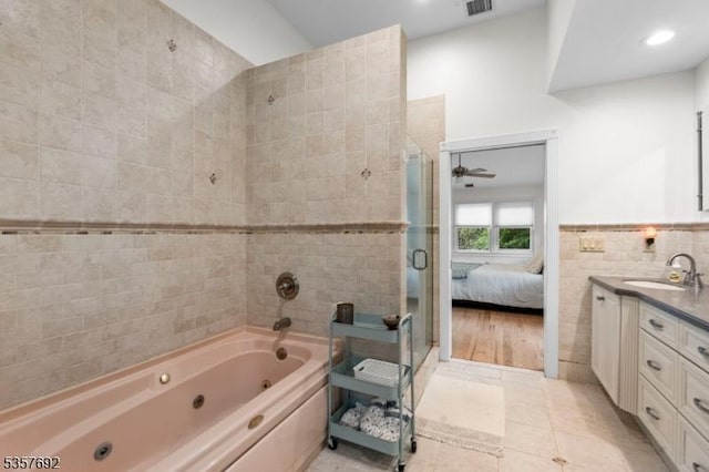 77 E Main St, Mendham Boro, NJ 07945 - ensuite bathroom featuring tile walls, a shower stall, vanity, a jetted tub, and tile patterned floors