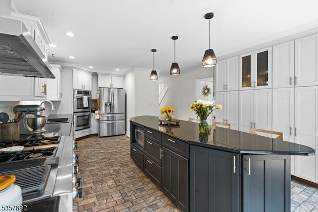 77 E Main St, Mendham Boro, NJ 07945 - kitchen with appliances with stainless steel finishes, wall chimney range hood, dark countertops, white cabinetry, and recessed lighting