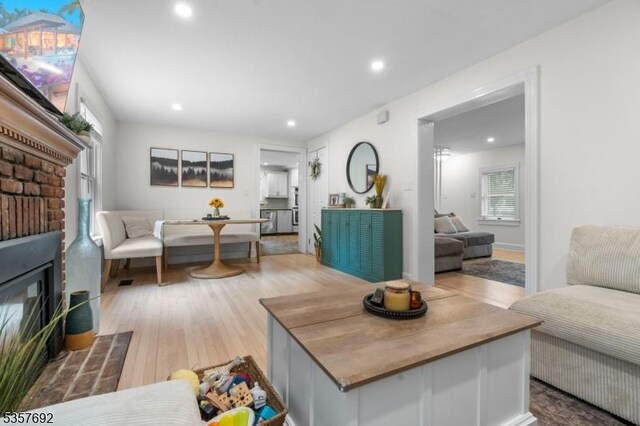 77 E Main St, Mendham Boro, NJ 07945 - living room featuring a brick fireplace, light wood-style floors, recessed lighting, and plenty of natural light
