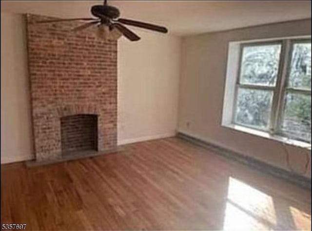 57 N 7th St, Newark City, NJ 07107 - unfurnished living room with ceiling fan, healthy amount of natural light, and wood finished floors