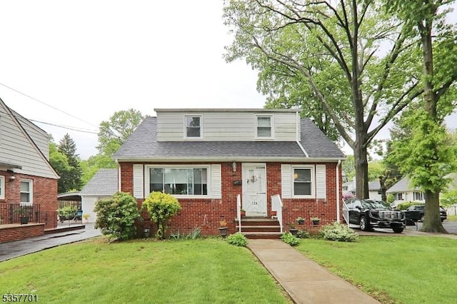 bungalow-style house featuring entry steps, brick siding, a front lawn, and a shingled roof