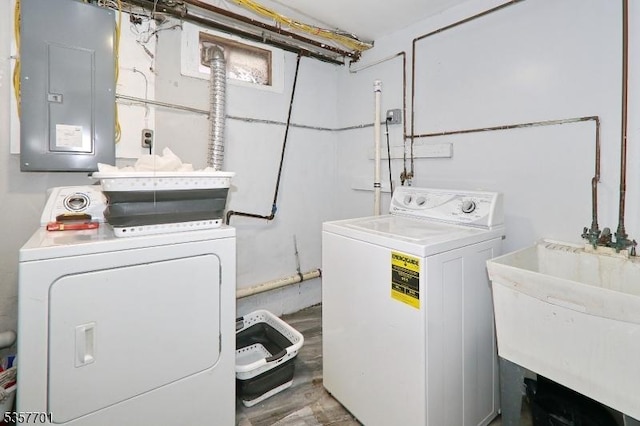 clothes washing area featuring independent washer and dryer and electric panel