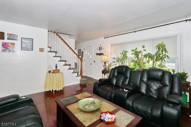 living area featuring stairs, wood finished floors, and baseboards