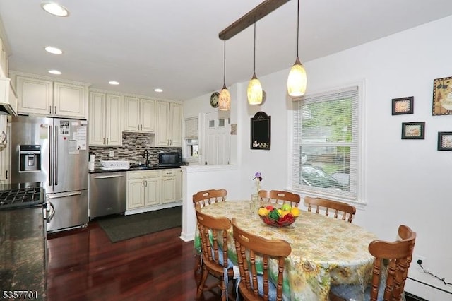 dining space with dark wood-type flooring and recessed lighting