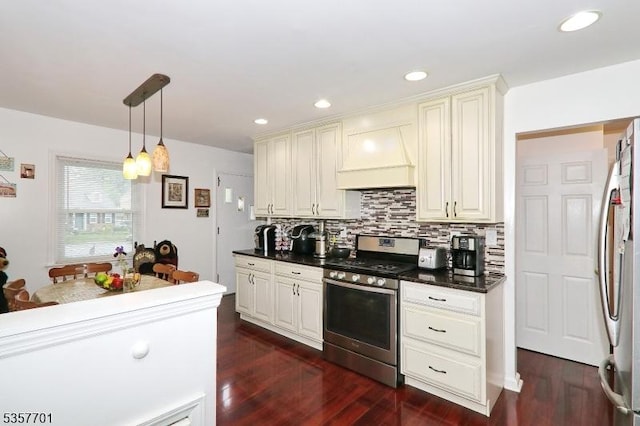 kitchen with stainless steel appliances, premium range hood, tasteful backsplash, dark countertops, and dark wood-style flooring