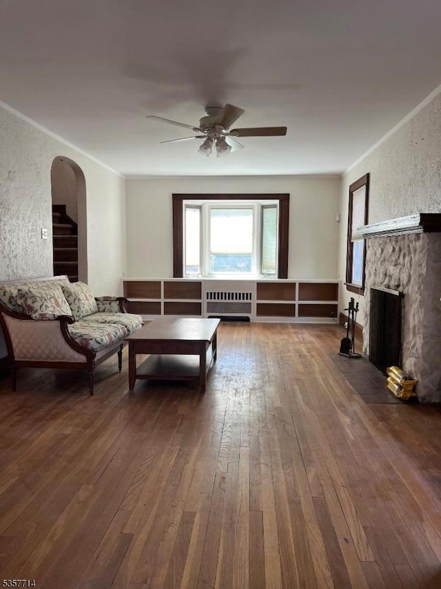 201 W Passaic Ave, Bloomfield Twp, NJ 07003 - living area with radiator heating unit, hardwood / wood-style flooring, ornamental molding, arched walkways, and a ceiling fan