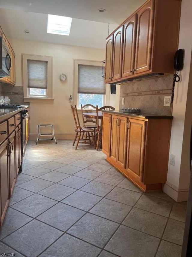 201 W Passaic Ave, Bloomfield Twp, NJ 07003 - kitchen featuring appliances with stainless steel finishes, dark countertops, backsplash, and light tile patterned floors