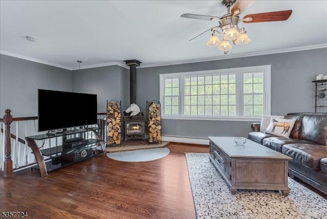 1011 Stillwater Rd, Stillwater Twp, NJ 07860 - living room with a baseboard radiator, wood finished floors, a wood stove, a ceiling fan, and ornamental molding