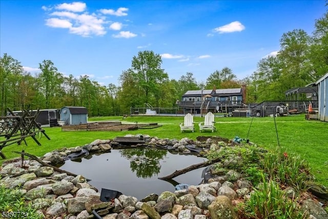 1011 Stillwater Rd, Stillwater Twp, NJ 07860 - view of storm shelter featuring a yard, a shed, an outdoor structure, and a small pond