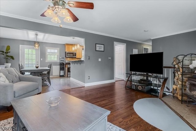 1011 Stillwater Rd, Stillwater Twp, NJ 07860 - living area with wood finished floors, a ceiling fan, ornamental molding, and baseboards