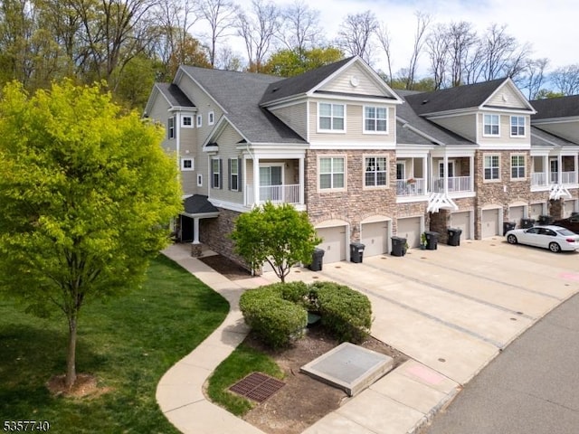 302 Waterview Ct, Hanover Twp, NJ 07927 - view of front of home with stone siding, an attached garage, driveway, and a front lawn