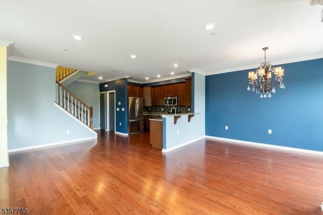 302 Waterview Ct, Hanover Twp, NJ 07927 - kitchen featuring stainless steel appliances, open floor plan, a chandelier, a breakfast bar, and a peninsula