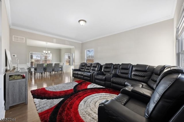 783 Aborn Ave, Woodbridge Twp, NJ 07095 - living area featuring wood finished floors, crown molding, a chandelier, wainscoting, and plenty of natural light