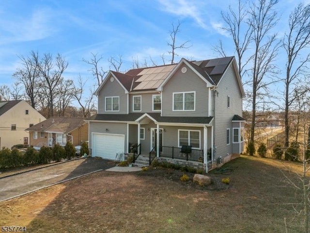 783 Aborn Ave, Woodbridge Twp, NJ 07095 - view of front of property featuring covered porch, a garage, roof mounted solar panels, and asphalt driveway