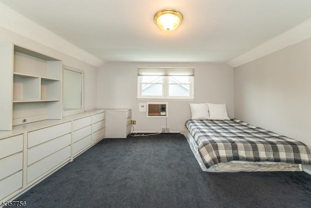 unfurnished bedroom featuring dark colored carpet and lofted ceiling