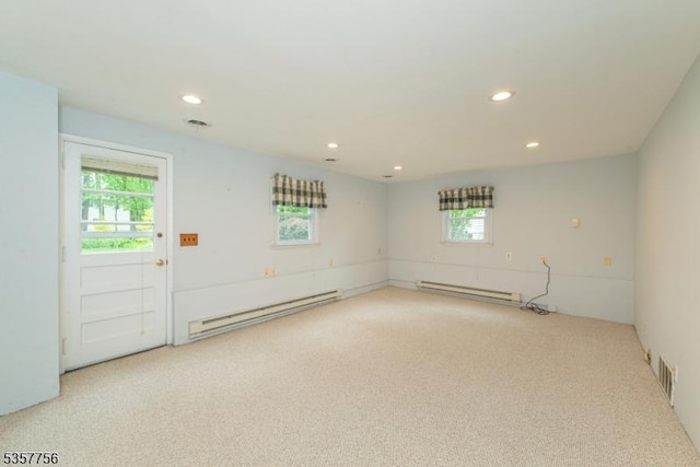 spare room with a baseboard heating unit, carpet, healthy amount of natural light, and recessed lighting