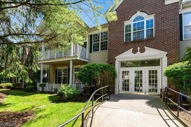 1302 Four Seasons Dr, Wayne Twp, NJ 07470 - rear view of property with french doors, a balcony, brick siding, and a yard
