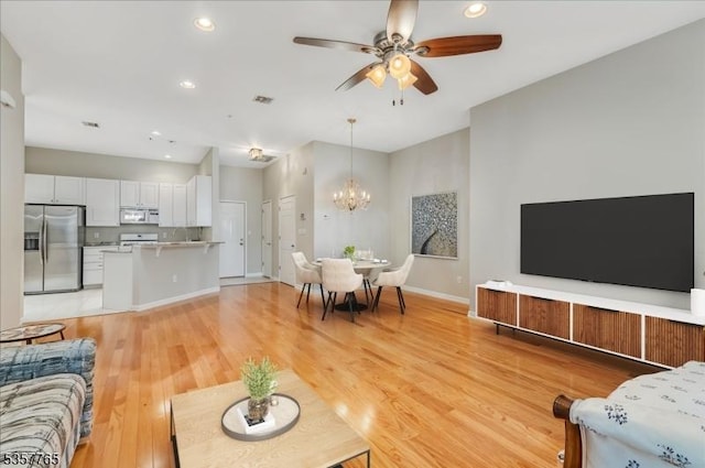 1302 Four Seasons Dr, Wayne Twp, NJ 07470 - living room featuring a chandelier, a ceiling fan, light wood-type flooring, recessed lighting, and baseboards
