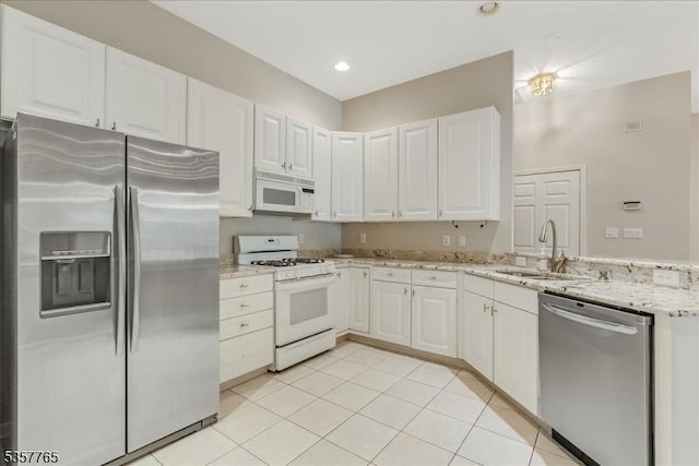 1302 Four Seasons Dr, Wayne Twp, NJ 07470 - kitchen with appliances with stainless steel finishes, a sink, a peninsula, light stone countertops, and white cabinets