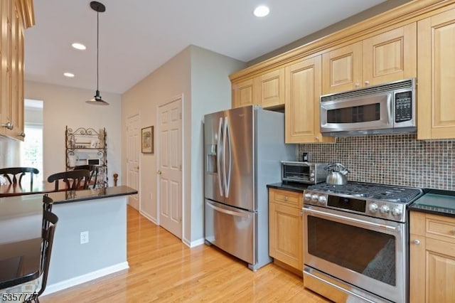 15 Riga Ct, Scotch Plains Twp, NJ 07076 - kitchen with appliances with stainless steel finishes, dark countertops, light wood finished floors, light brown cabinetry, and recessed lighting