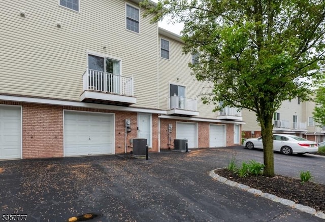 15 Riga Ct, Scotch Plains Twp, NJ 07076 - rear view of house featuring brick siding, an attached garage, and central air condition unit