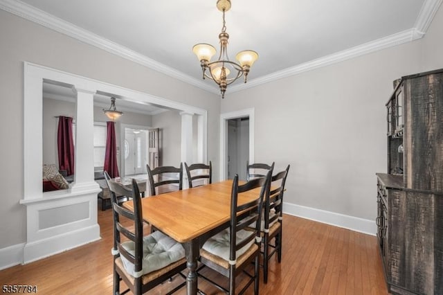 40 Laura Ave, Nutley Twp, NJ 07110 - dining room with decorative columns, wood-type flooring, a chandelier, ornamental molding, and baseboards