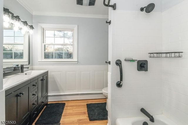 full bath with baseboard heating, crown molding, double vanity, wood finished floors, and shower / tub combination