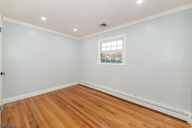 spare room with a baseboard radiator, light wood-type flooring, crown molding, recessed lighting, and baseboards