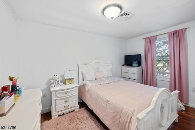 bedroom featuring wood finished floors and baseboards