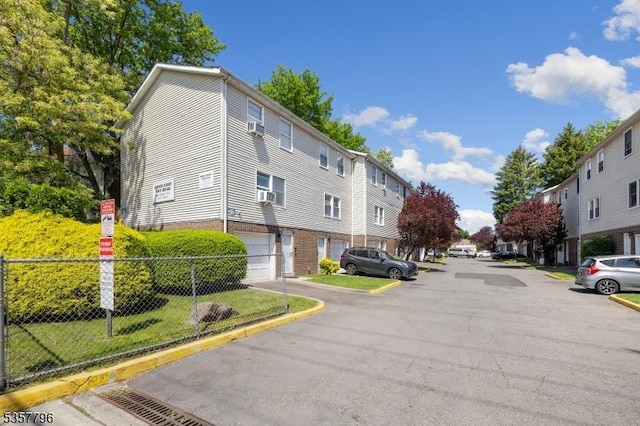 view of asphalt road with curbs and a residential view