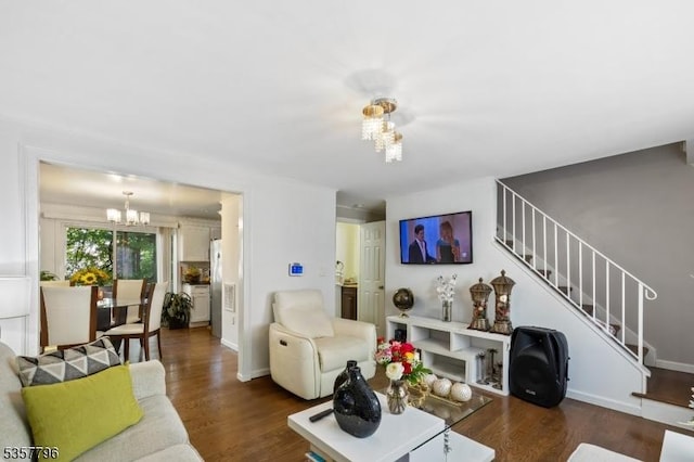 living area featuring a chandelier, stairs, wood finished floors, and baseboards