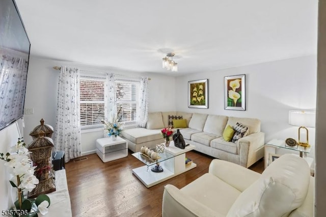 living area with wood finished floors and baseboards