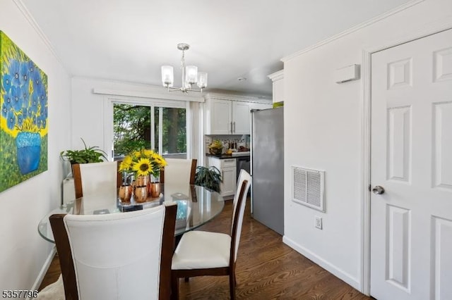 dining area featuring a chandelier, dark wood-type flooring, and baseboards