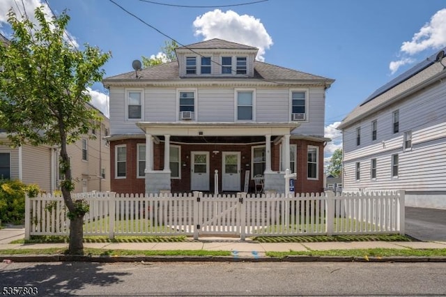 632 Floral Ave, Elizabeth City, NJ 07208 - traditional style home featuring covered porch, a fenced front yard, roof with shingles, and brick siding