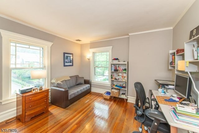 home office featuring wood finished floors, ornamental molding, and baseboards