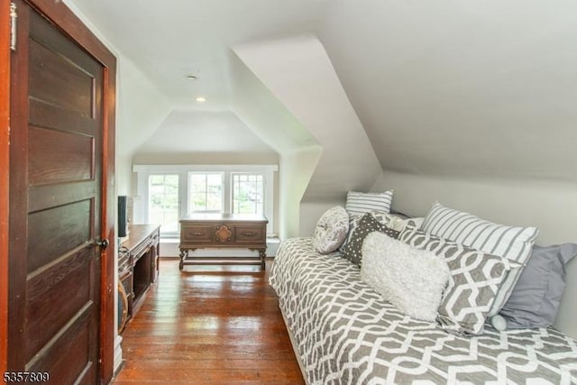 bedroom with dark wood finished floors, vaulted ceiling, and recessed lighting